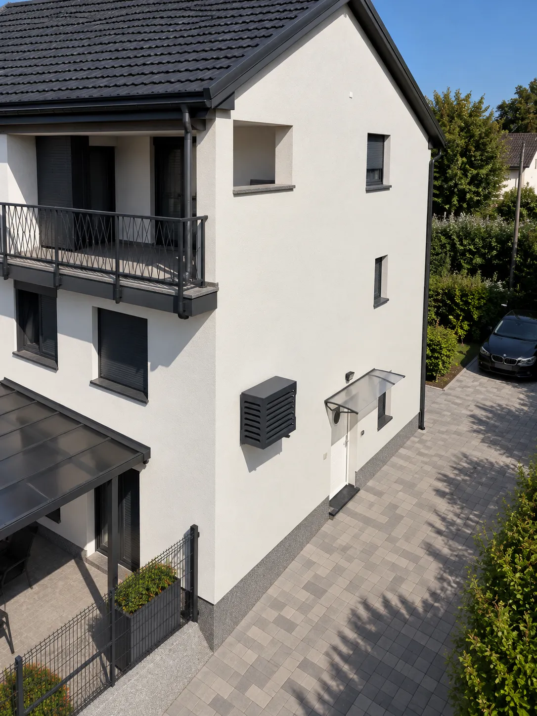 Matro louvered cover mounted on the white rendered facade of a family house